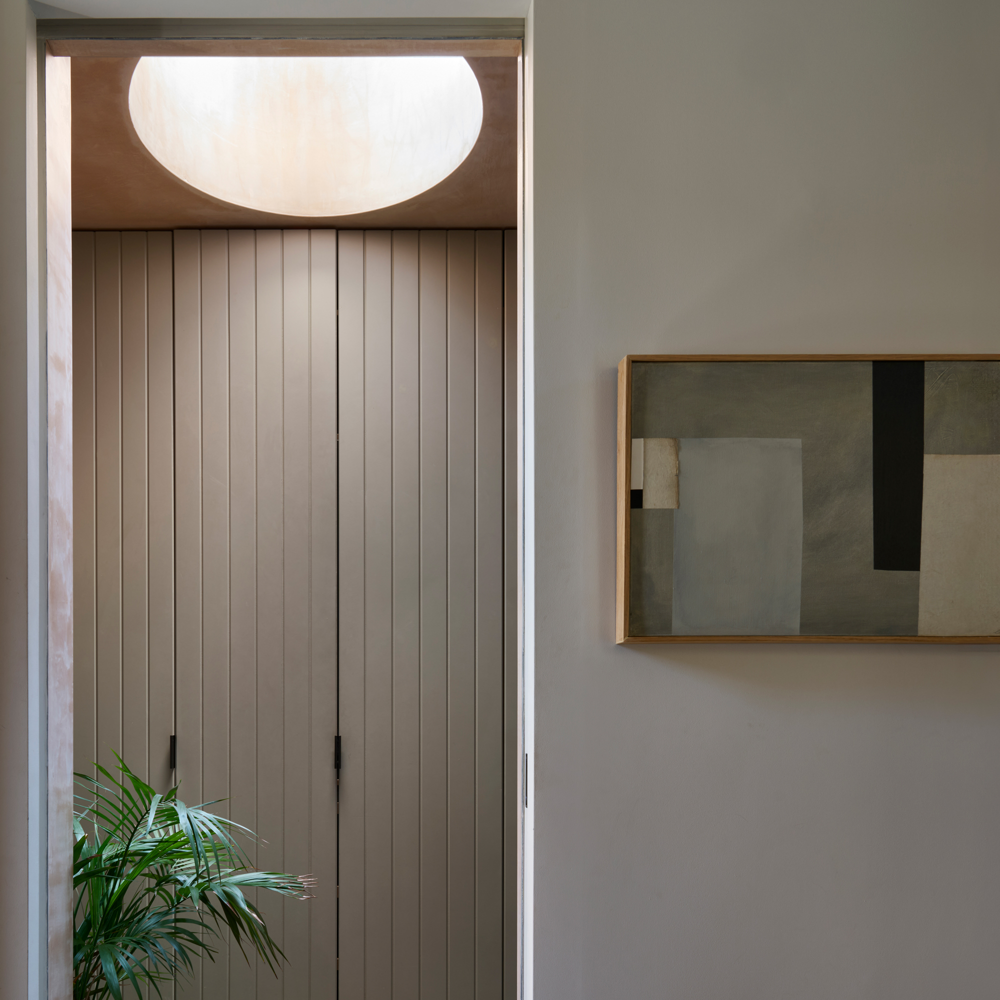 hallway with skylight and fitted storage cupboards
