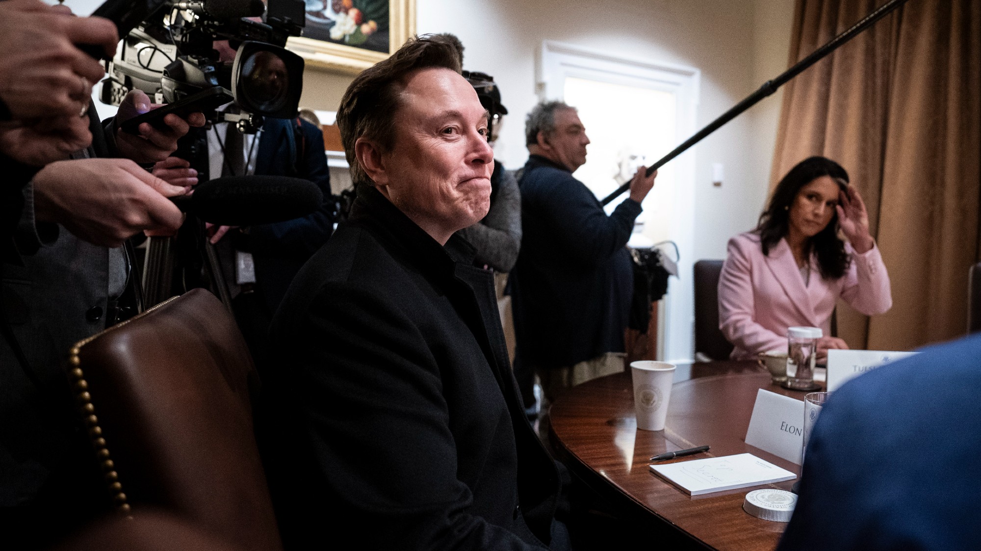 Elon Musk listens as President Donald J Trump speaks during a cabinet meeting at the White House 