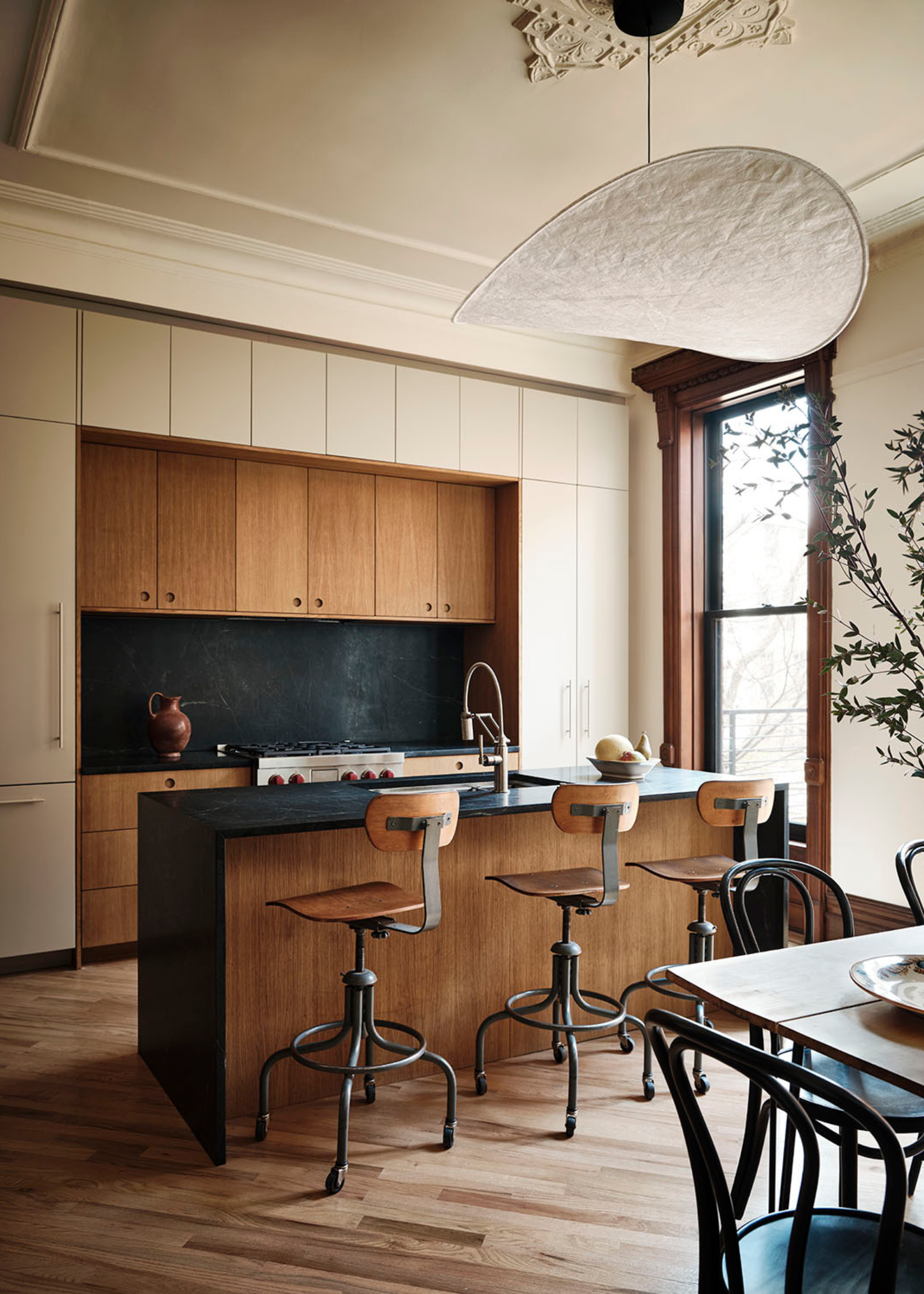 beautiful modern kitchen in a period home with a combination of cream and wooden cabinets