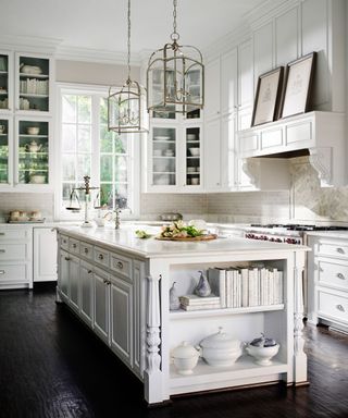White farmhouse kitchen with traditional cabinets, marble splashbacks and antiques
