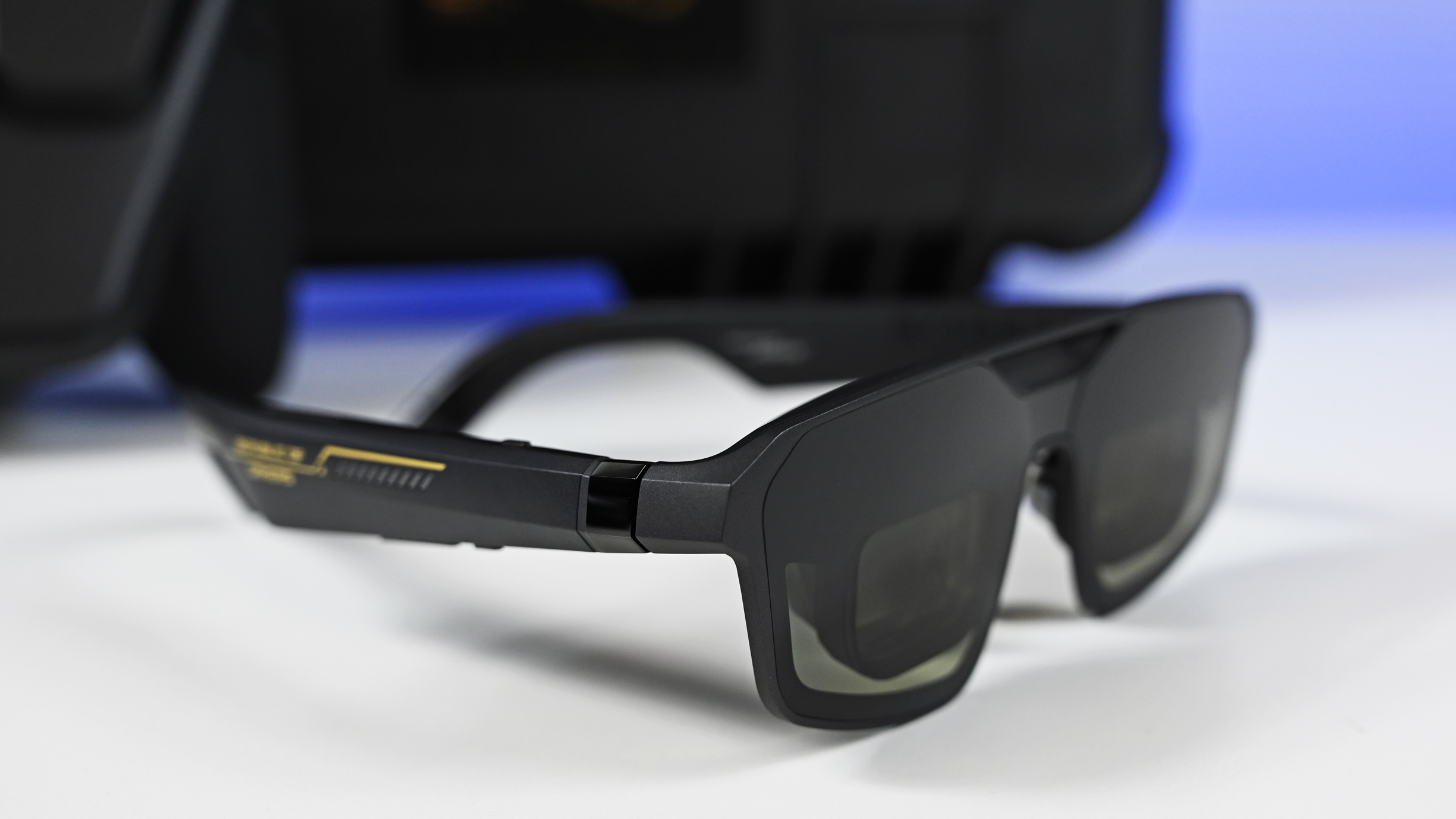 Three-quarter angle view of the ROG XREAL R1 Edition 20 AR smart glasses resting on a white tabletop.