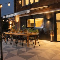 outdoor living space with festoon lighting and dining table