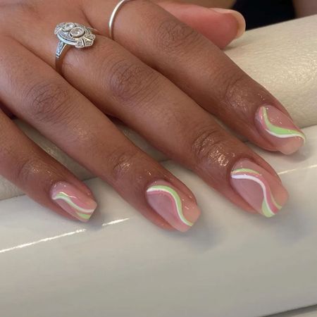 A pastel green and pink swirl nail design
