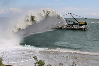 A ship dredges sand and water from the shore for a construction project in Odessa, Ukraine.