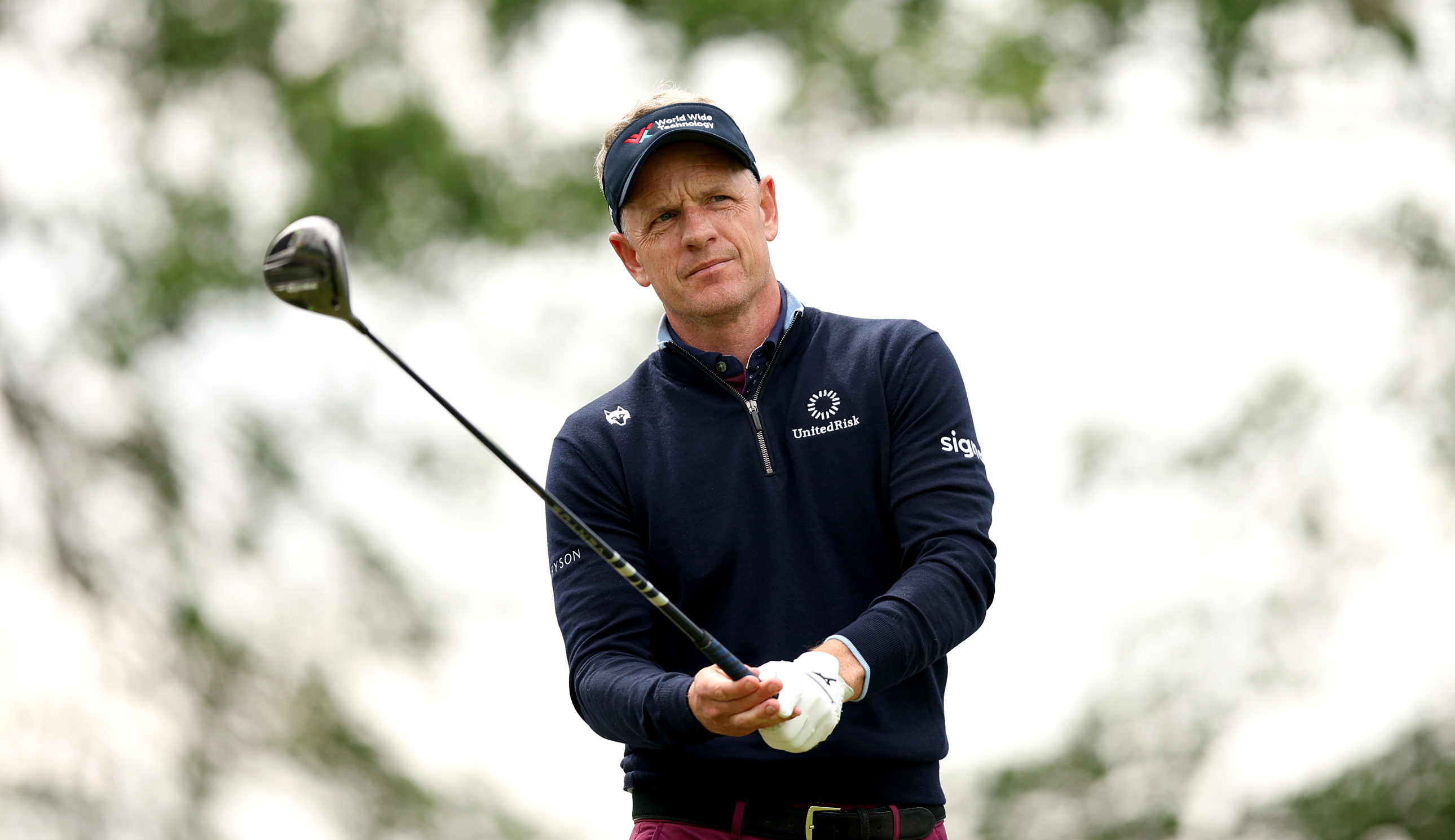 Luke Donald lines up a shot with a driver