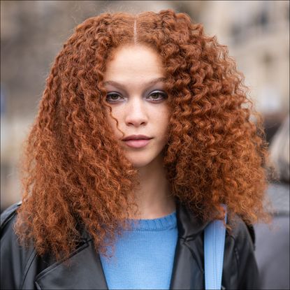 A guest with curly hair is seen outside Chanel, during Paris Fashion Week - Womenswear Fall Winter 2023 2024, on March 07, 2023 in Paris, France