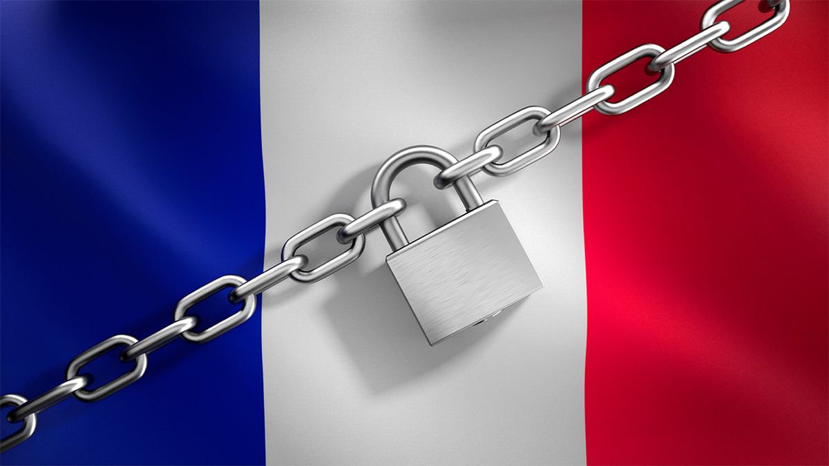 French flag with silver padlock and chain in front of it 