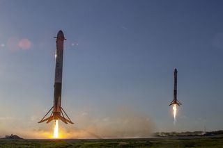 Two SpaceX Falcon Heavy first-stage boosters ace their landings shortly after helping launch the Arabsat-6A satellite on April 11, 2019.