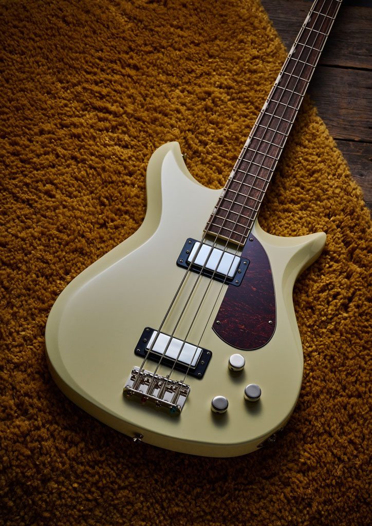 Gretsch Electromatic CVT Bass Double-cut: the retro-styled cream-colored four-string is pictured in close-up against a shaggy brown carpet.