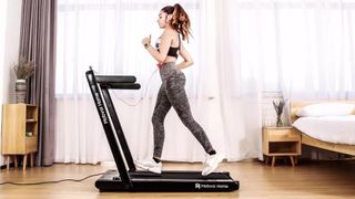 A woman runs on the Mobvoi treadmill in her living room