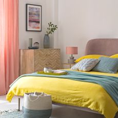 Pink bedroom with curtains and yellow bedding