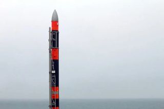 black and white rocket with fog and sea in behind