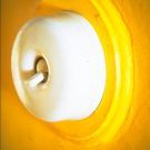 white coloured bakelite switch with yellow background