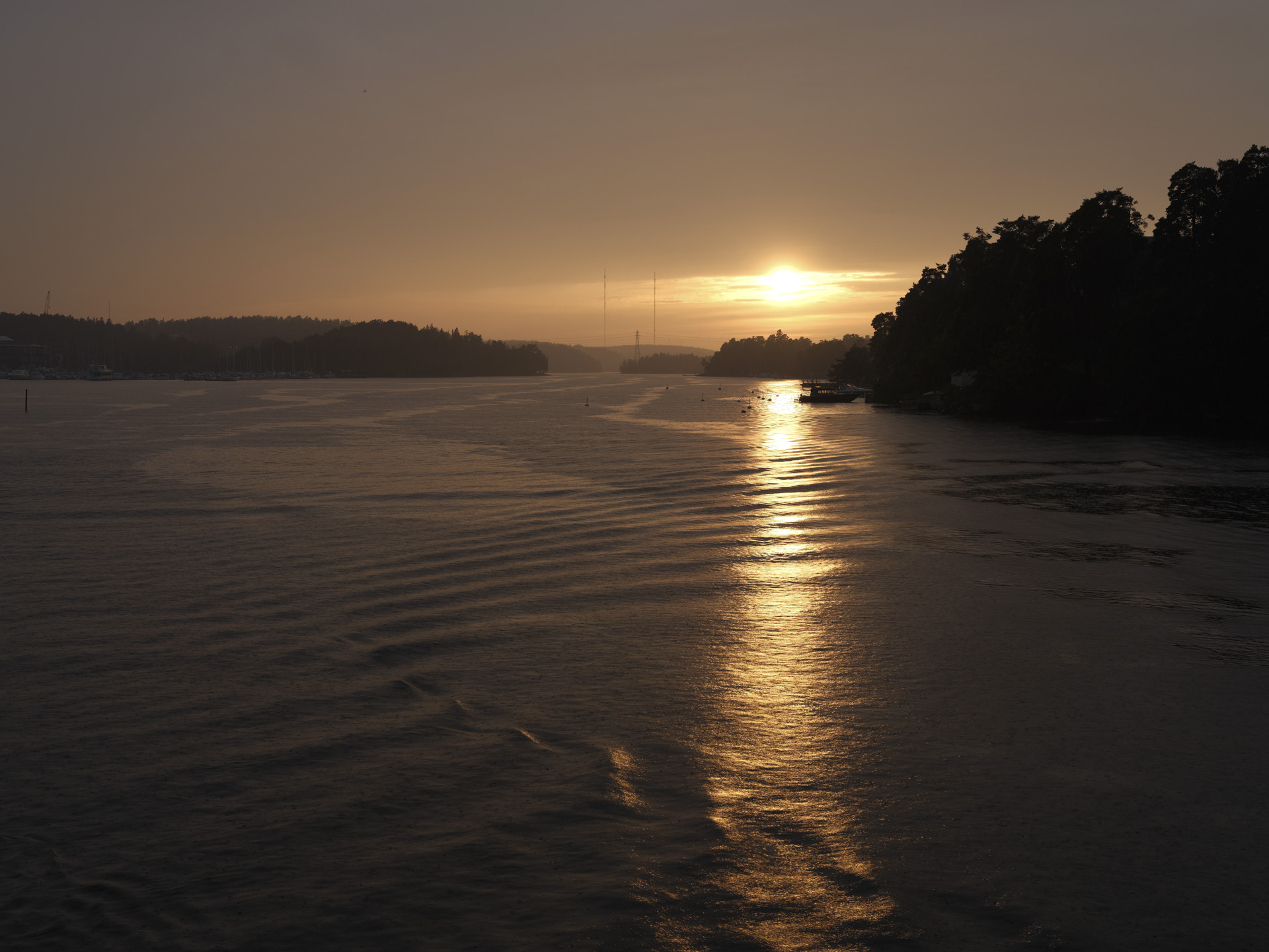 Sunset over a lake from the vantage point of a boat