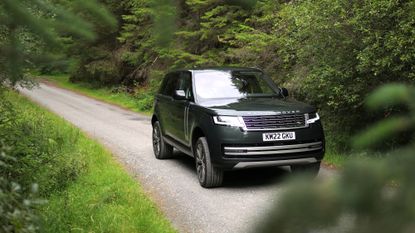 New Range Rover in a forrest in Scotland