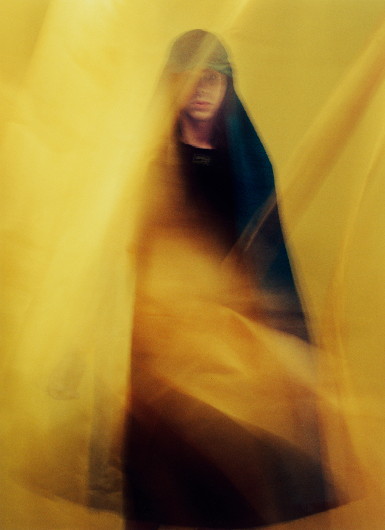 Man in cape cap by Raf Simons