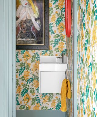 cloakroom with patterned wallpaper and large artwork