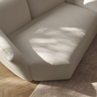 Detail of cream coloured 'Timeless' sofa by Lorenza Bozzoli in neutral toned living room