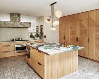 Mid-century kitchen with marble countertop and wood cabinets