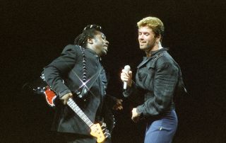 LONDON, UNITED KINGDOM - JUNE 15: Bass player Deon Estus and George Michael perform on stage on the 'Faith' tour, at Earls Court Arena on June 15th, 1988 in London, England.