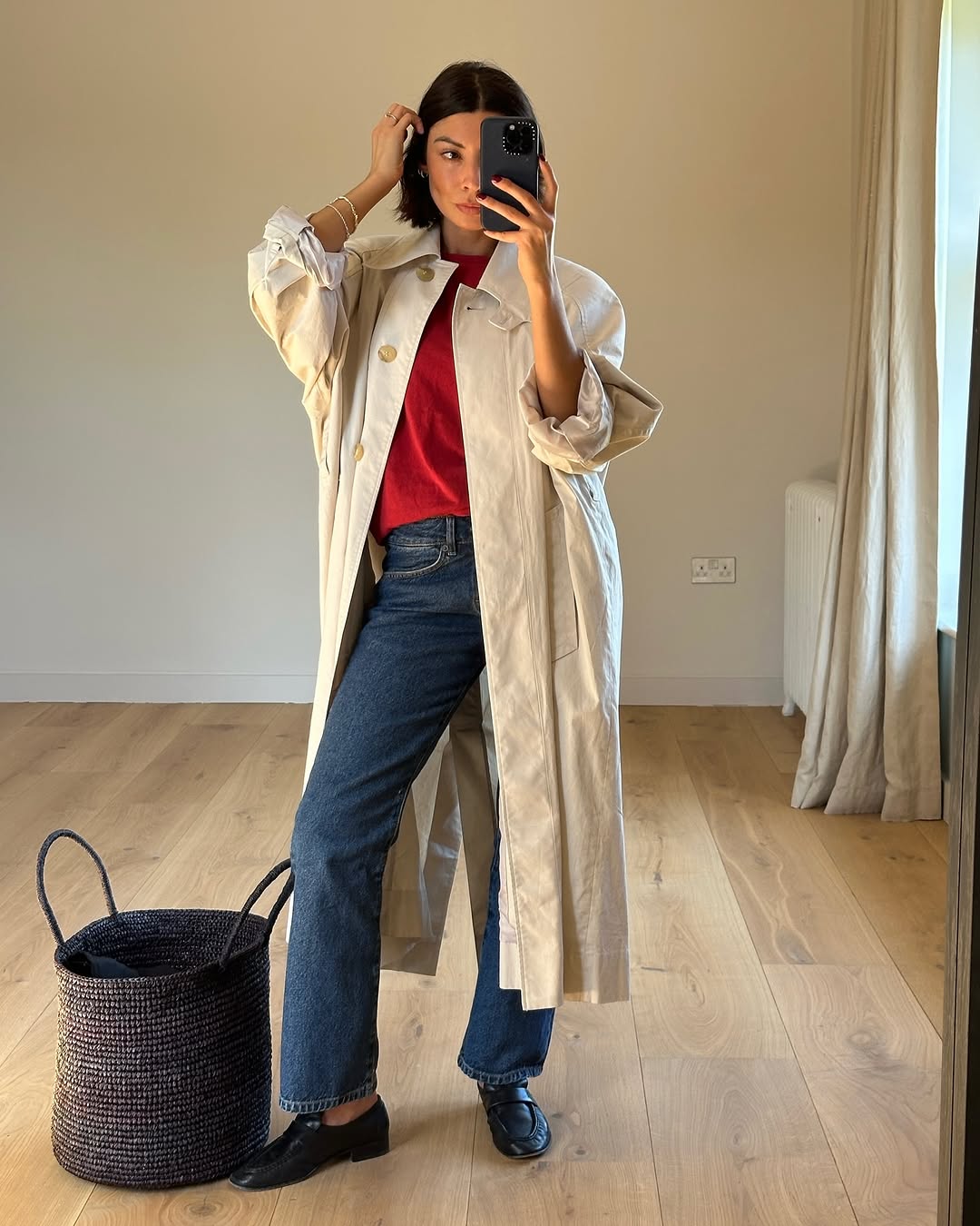 Woman wearing dark wash bootcut jeans fall 2025.