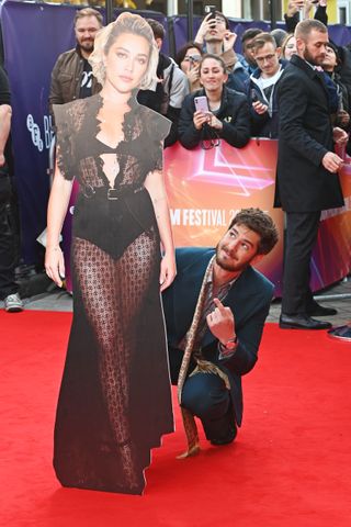 Andrew Garfield and a cardboard cut-out of Florence Pugh