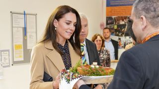 Catherine, Princess of Wales receives bread and salt on her arrival as she visits the Reading Ukrainian Community Centre on November 17, 2022