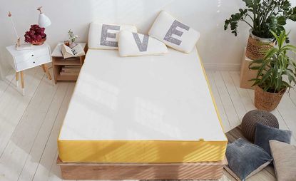 eve mattress review - Eve mattress discount code - Eve mattress on bed with pillows spelling EVE
