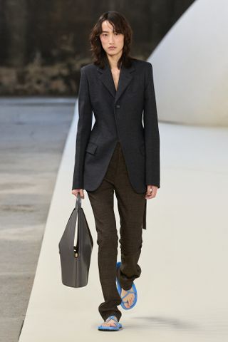 a Tod's model walks the spring/summer 2025 runway in skinny trousers