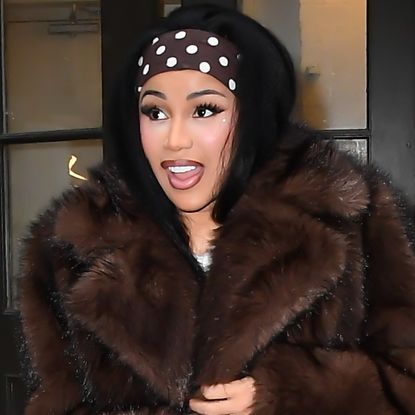 Cardi B was seen in New York City wearing a polka-dot take on the stirrup leggings trend, a matching dress, and headband