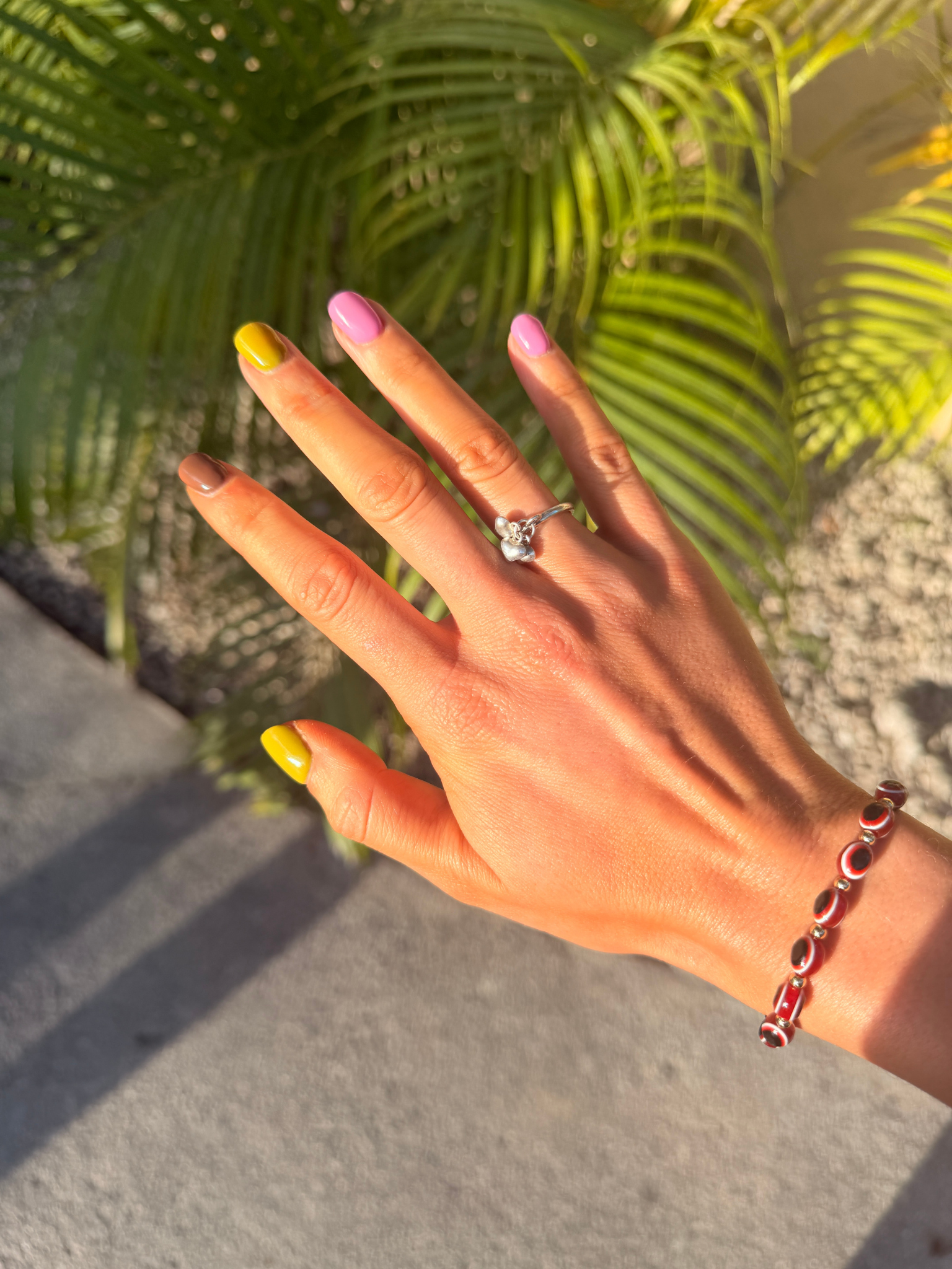 multi-coloured yellow pink and brown nails