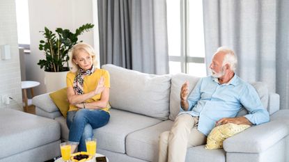 Senior couple discussing divorce while sitting in their living room