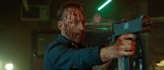 Bob Odenkirk holding a gun in Nobody 2