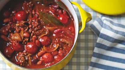 Chilli Con Carne in a yellow pan on a blue and white gingham table cloth