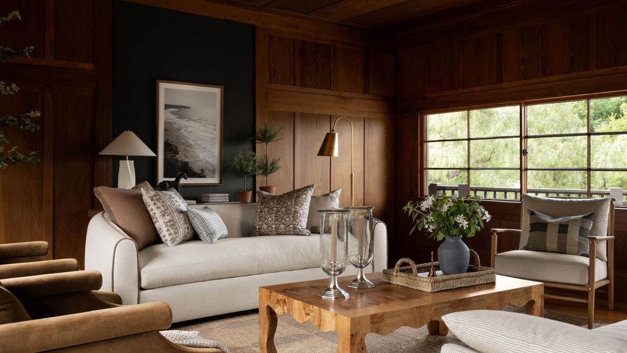 A living room with a console table behind a sofa