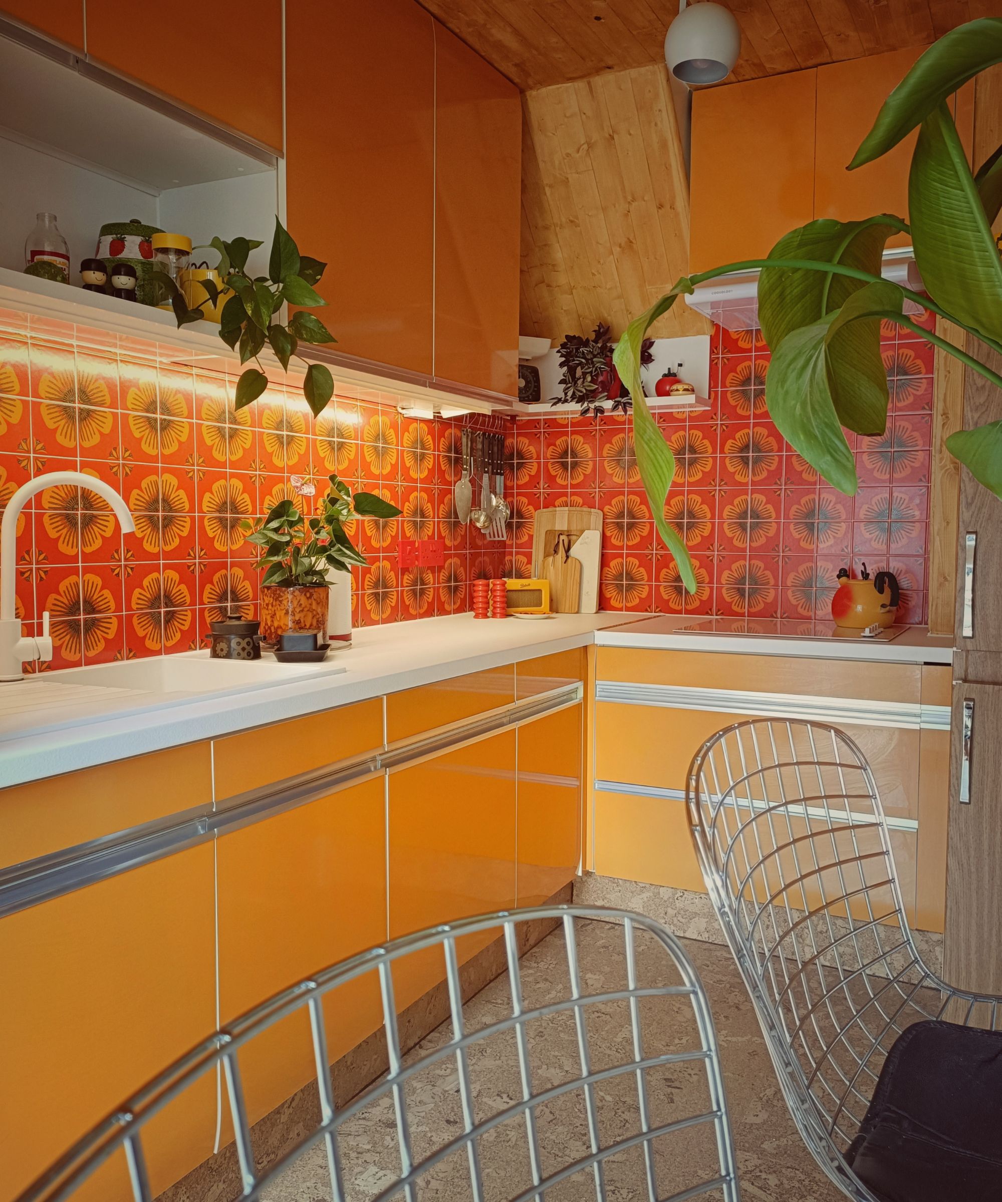 1970s kitchen with orange Formica cabinets and orange wall tiles