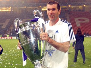 Zinedine Zidane holds the Champions League trophy after Real Madrid's victory over Bayer Leverkusen in the 2002 final at Hampden Park in Glasgow, Scotland