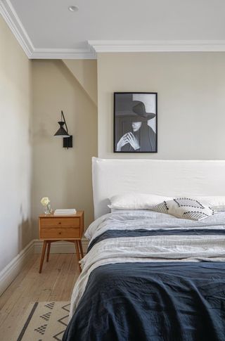 A small bedroom with a wall mounted light in black