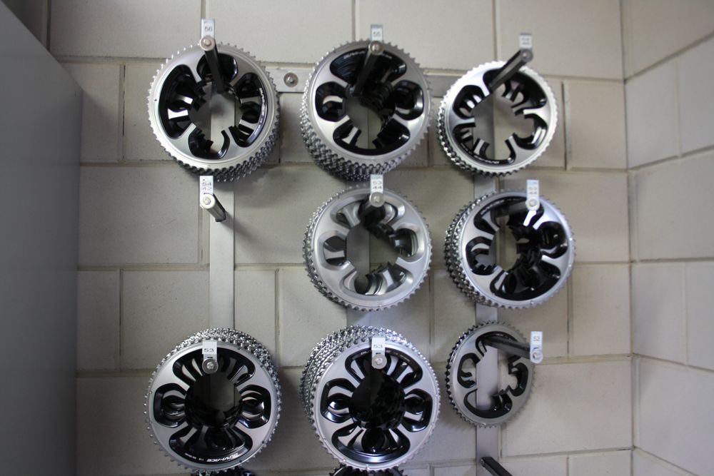 A litter of chainrings decorate the wall