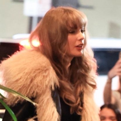 Taylor Swift in New Orleans ahead of the Super Bowl 2025 wearing a coat with fluffy sleeves