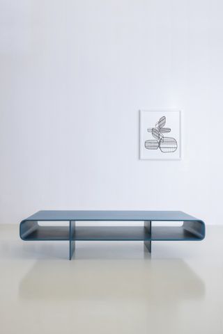 Barber Osgerby Loop table in blue, photographed in a minimalist space