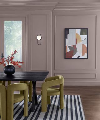 dining room with purple walls, artwork, dining table with olive green chairs