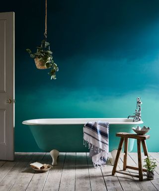 Blue bathroom with a blue painted bathtub