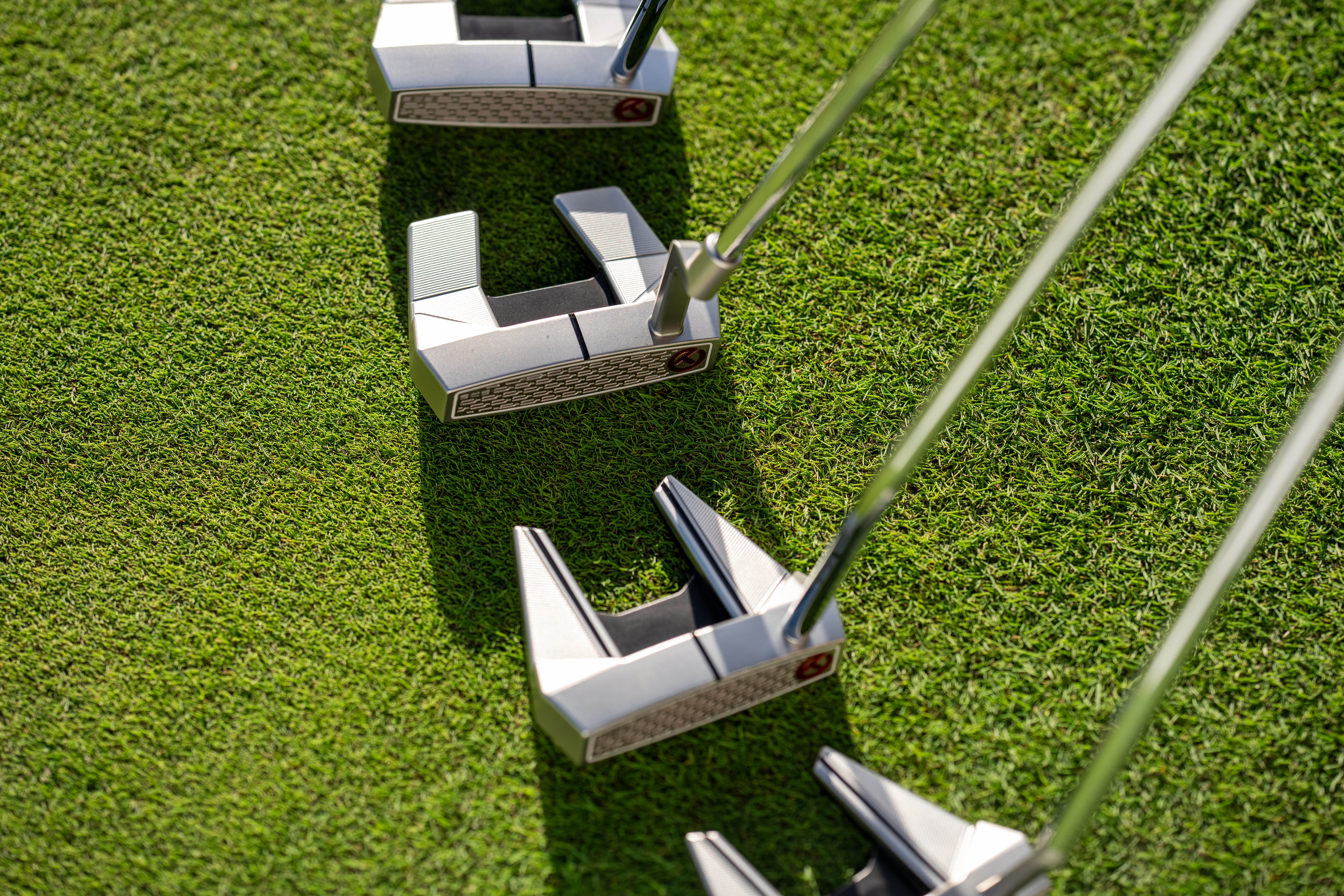 A number of Scotty Cameron putters lined up