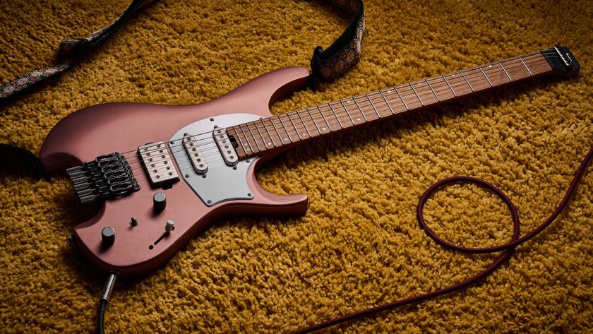 Ibanez Q54W: the headless electric guitar is finished in Copper Metallic Matte and photographed against a thick light-tan colored carpet.