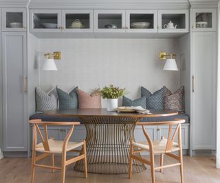 Grey cabinets and seat cushions, wooden chairs