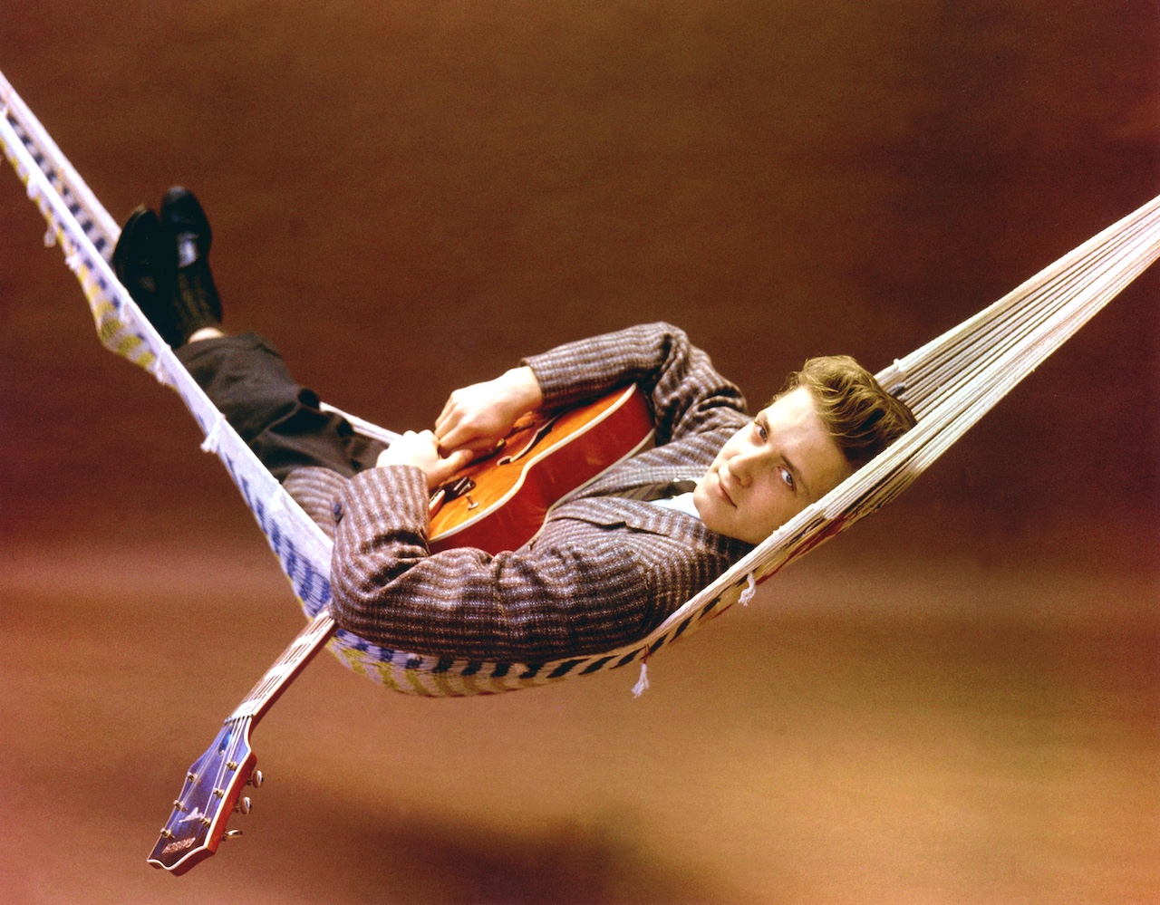 Eddie Cochran lying in a hammock in 1959, cradling his Gretsch 6120