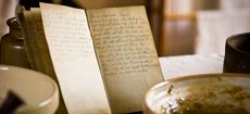 A hand-written recipe book (cookbook) by a baking bowl in a Victorian Kitchen