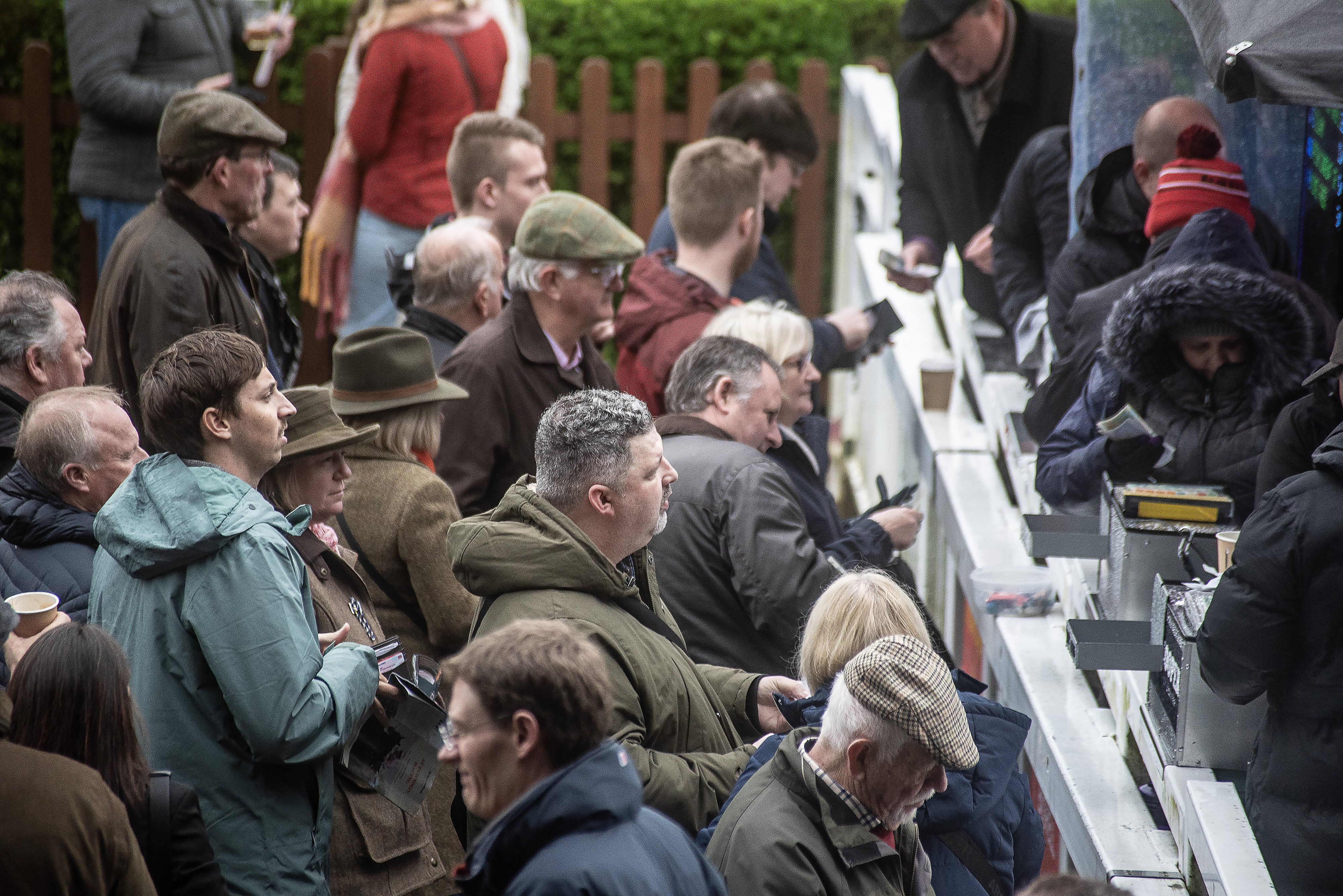 Use your telephoto lens to zoom in to capture people collecting their winning or candids of people in the crowd.