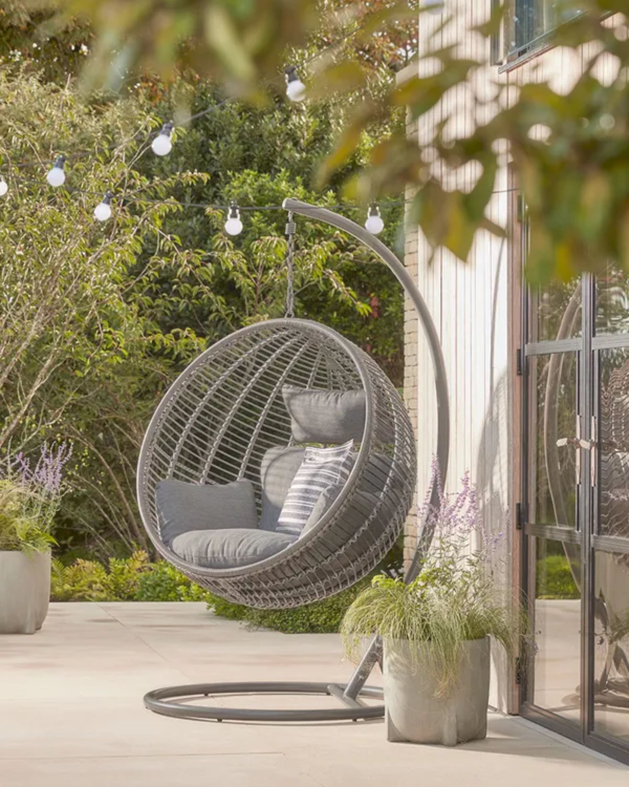 gray hanging egg chair on modern garden patio